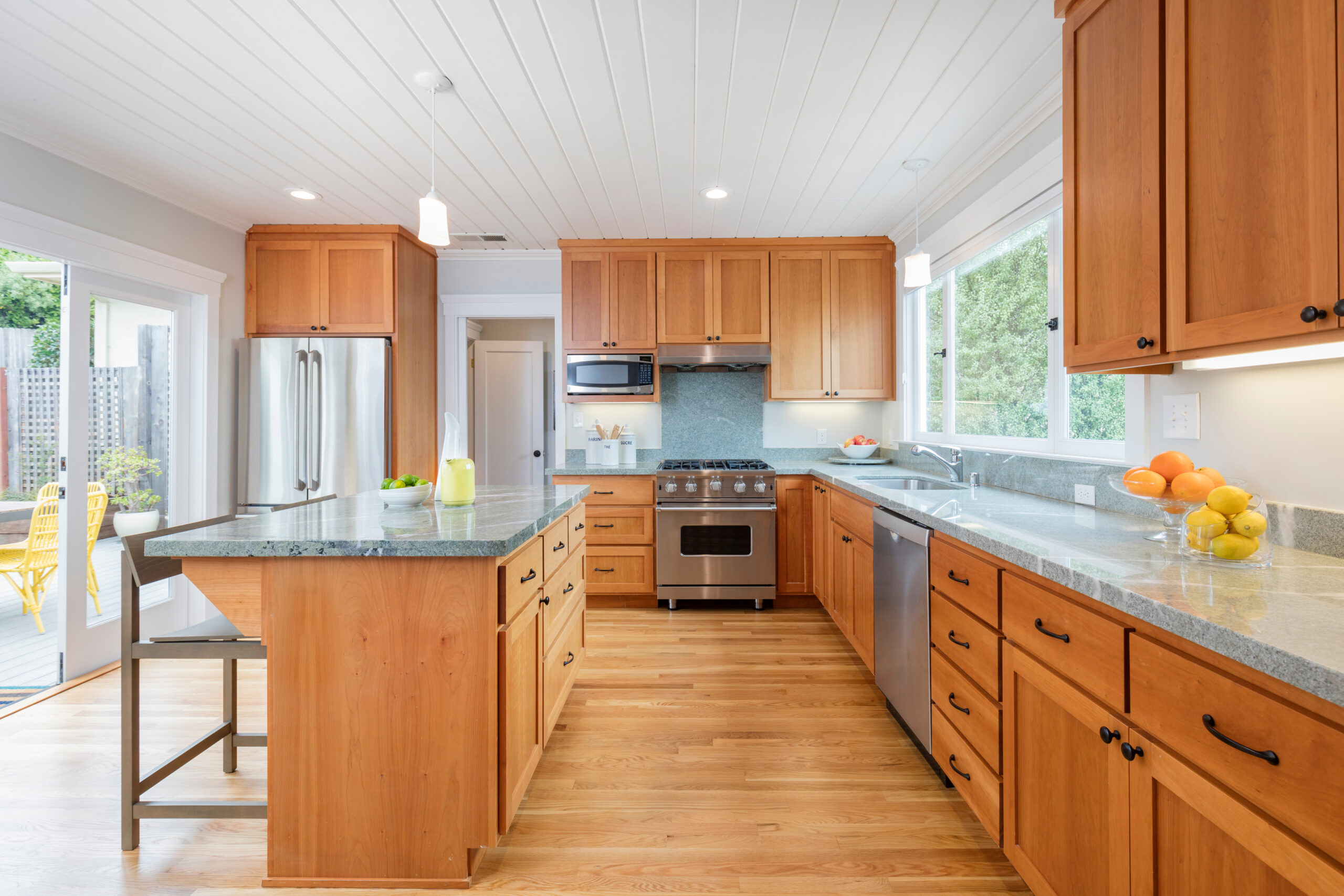 Kitchen with cherry wood cabinetry and stone countertops