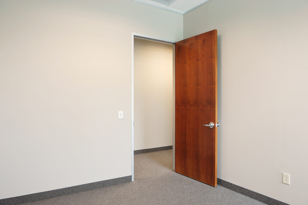 Empty office with an open wood door