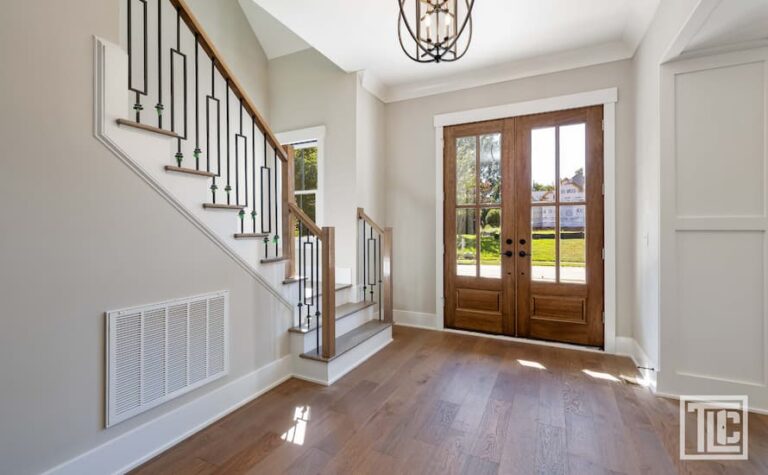 Contractor measuring doors for non-standard openings on an older North Georgia home during a remodel